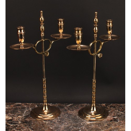 1945 - A pair of early 20th century brass two-light adjustable candelabra, orb-and-knop finiasls, broad dri... 