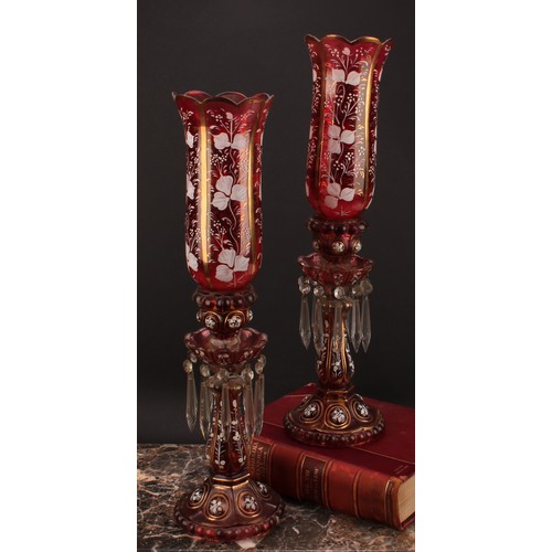 2188 - A pair of Bohemian cranberry flashed glass storm lantern candle lustres, decorated in opaque enamel ... 