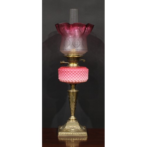 1939 - A Victorian brass and pink Vaseline glass table oil lamp, etched cranberry flashed shade, the base c... 