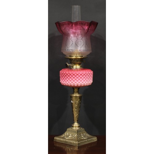 1939 - A Victorian brass and pink Vaseline glass table oil lamp, etched cranberry flashed shade, the base c... 