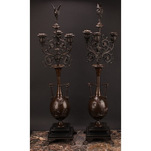 2182 - A pair of 19th century French brown patinated bronze table candelabra, stork finials, each vasular p... 