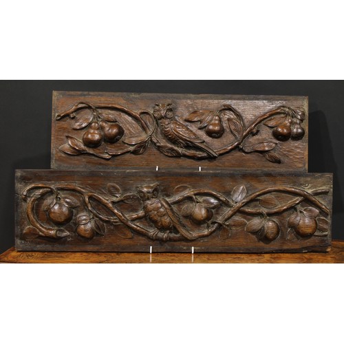 2186 - A pair of 19th century oak rectangular panels, each boldly carved with an owl amongst fruiting apple... 