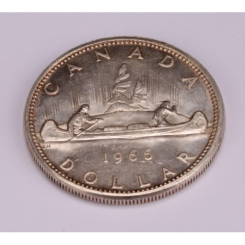 1200 - Coins - an Elizabeth II silver Canadian dollar, small beads, 1966