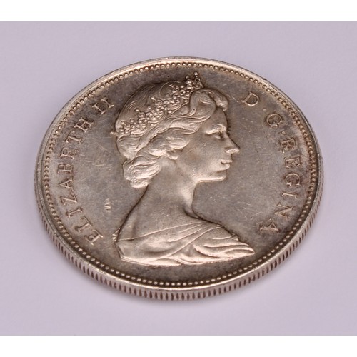 1200 - Coins - an Elizabeth II silver Canadian dollar, small beads, 1966