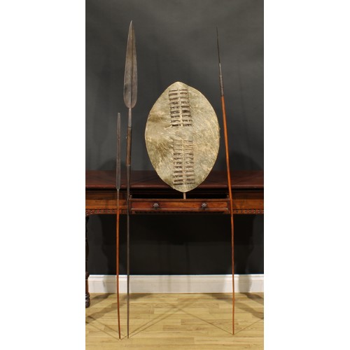 1503 - A Maasai spear, 174cm long, Kenya, 19th century; others; a Zulu hide shield, 60cm long, South Africa... 