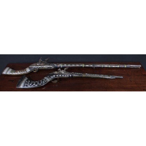 1493 - A 19th century Afghan flintlock jezail, 90cm barrel, full stock inlaid with mother of pearl, 126cm l... 