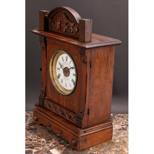 2488 - An early 20th century oak mantel alarm clock, 11.5cm circular enamel dial inscribed FATTORINI & SONS... 