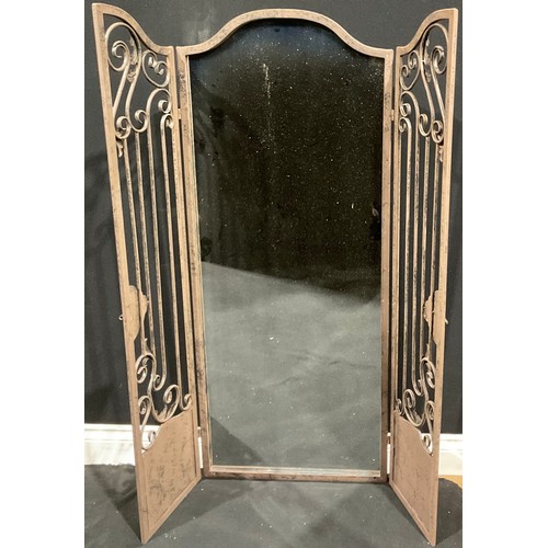 580 - Interior Decoration - a large arched top rectangular wall mirror set behind a pair of metal garden g... 