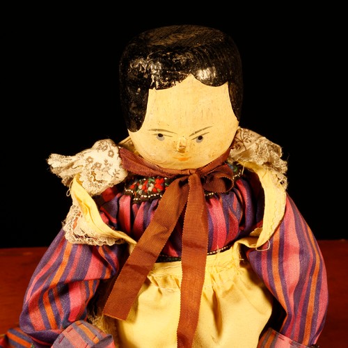 7097 - Folk Art - an early 20th century Grödnertal or 'Dutch' peg doll, the carved and painted head with pa... 