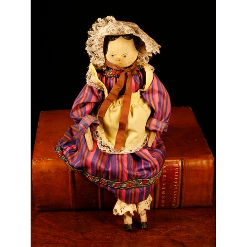 7097 - Folk Art - an early 20th century Grödnertal or 'Dutch' peg doll, the carved and painted head with pa... 