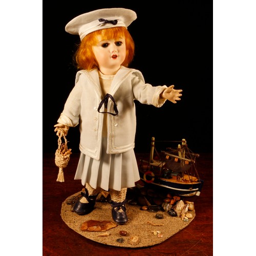 7105 - A reproduction bisque head doll, the bisque head inset with fixed blue glass eyes, painted features ... 