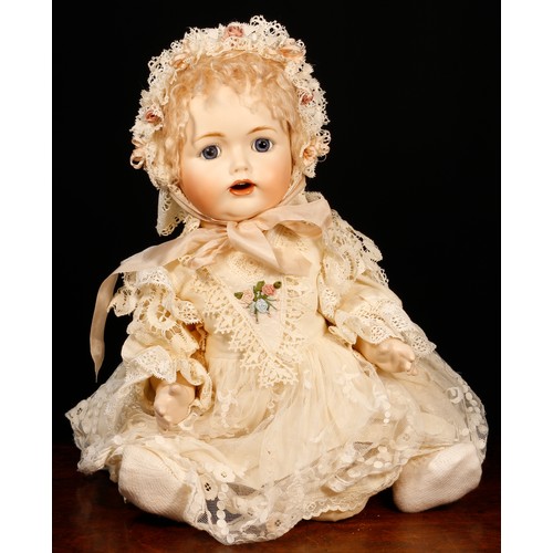 7107 - A reproduction bisque head and painted composition bodied doll, the bisque head inset with blue eyes... 