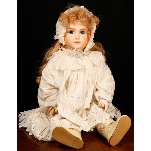 7112 - A reproduction bisque head doll, the bisque head inset with fixed blue glass eyes, painted features ... 