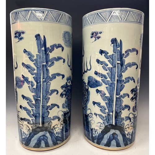 3019 - A pair of contemporary blue and white glazed circular floor standing sleeve vases, decorated in the ... 