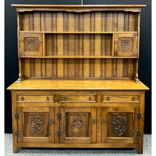 163 - A Tudor inspired oak dresser, by Fletcher Mayfield, model number 56/63, 183.5cm high x 167.5cm wide ... 