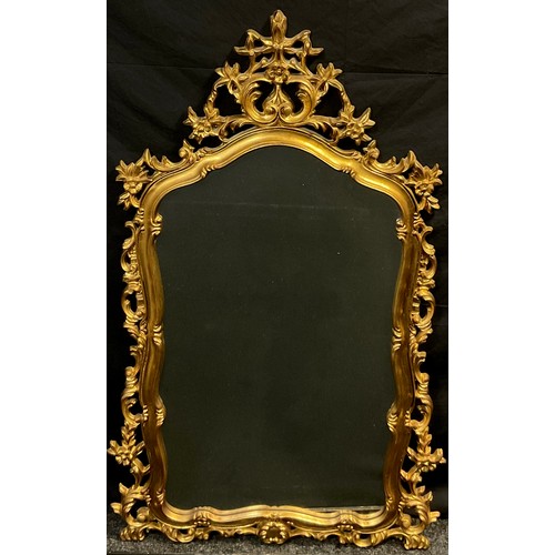 174 - An ornate 18th century style faux gilt wood mirror, 142cm high x 90cm wide.