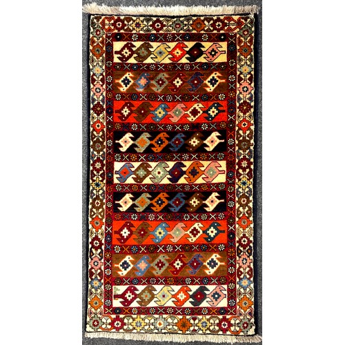 180 - A North-west Persian Yallemeh rug / carpet, hand-knotted in rich tones of red, blue, orange, and dee... 