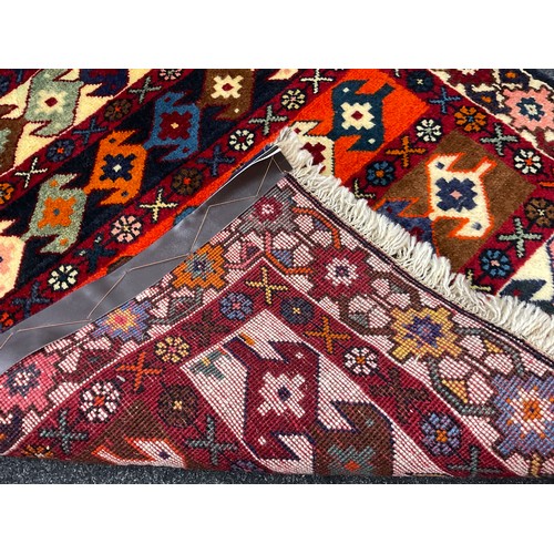 180 - A North-west Persian Yallemeh rug / carpet, hand-knotted in rich tones of red, blue, orange, and dee... 