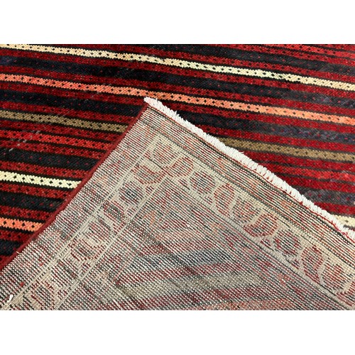 184 - A South-west Persian Lori rug / carpet, hand-knotted, in tones of red, pink, deep indigo, and cream,... 