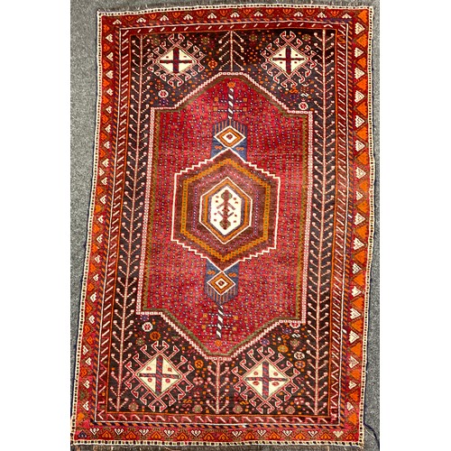 190 - A Persian style woollen rug / carpet, hand-knotted with central hexagonal medallion, within concentr... 