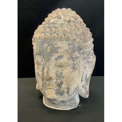 196 - A stone effect garden figure of Buddha head, 34cm high