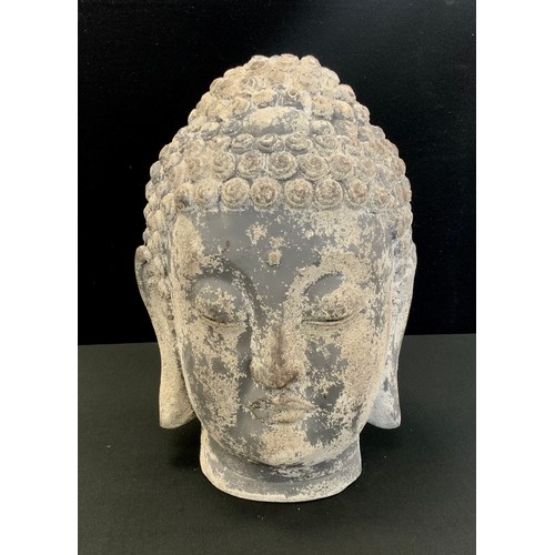 196 - A stone effect garden figure of Buddha head, 34cm high