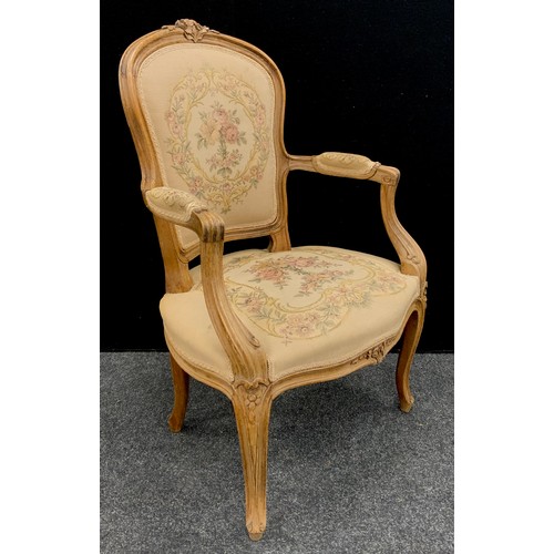 200 - A Louis XV revival carved beech fauteuil armchair.