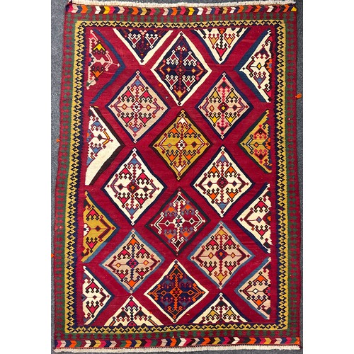 209 - A South-west Persian Qashgai Kilim rug / carpet, hand-knotted with a field of diamond shapes, in ton... 