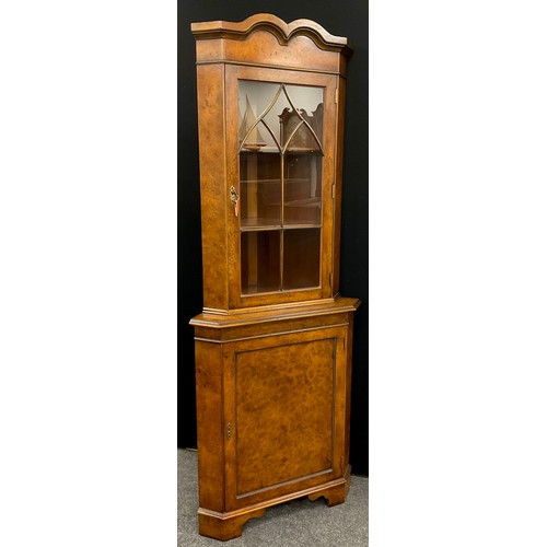 211 - A George III style reproduction burr walnut corner cabinet, 197.5cm high x 75cm wide.