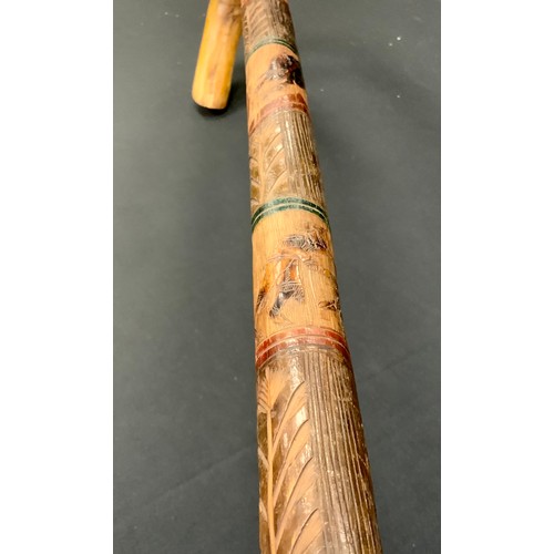 271 - A 1930s Mexican walking stick, carved and painted with the Mexican coat of arms above bull fighting ... 