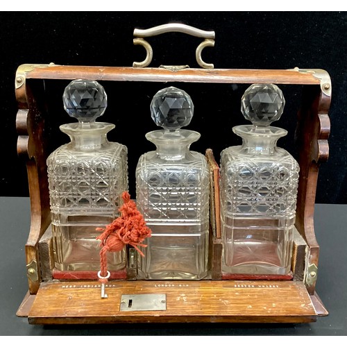 278 - A late Victorian oak three-bottle tantalus, c.1890