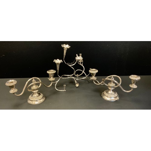 281 - An Art Nouveau silver plated table centre epergne/posy holder;  pair of two branch candlesticks  (3)