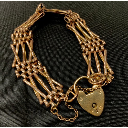 304 - A 9ct gold X bar cross link gate bracelet, padlock clasp, 1.5cm wide, 18.1g