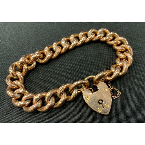 306 - A 9ct gold hollow curb link bracelet, padlock clasp, 26.6g