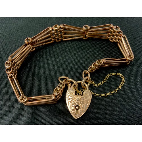 308 - A 9ct rose gold tapering fancy bar gate bracelet, pad lock clasp, 1.3cm wide, 19.4g