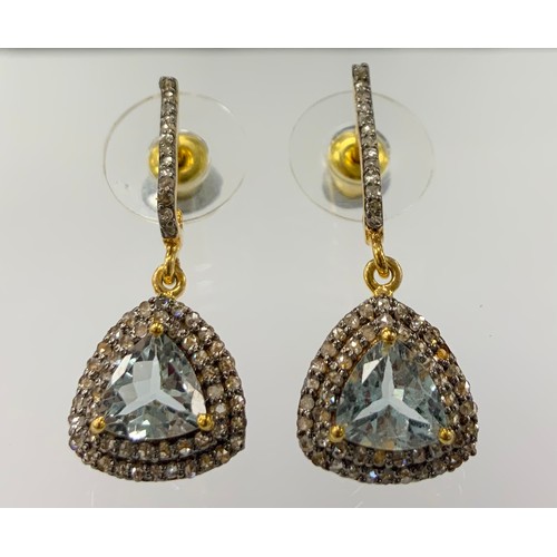 323 - A pair of aquamarine and diamond earrings, central trilliant cut aquamarine surrounded by a double l... 