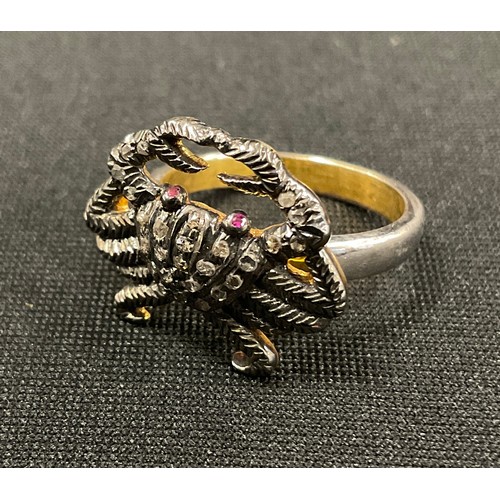 331 - An unusual diamond novelty ring, as a crab, pave encrusted with rose cut diamonds, ruby eyes, total ... 