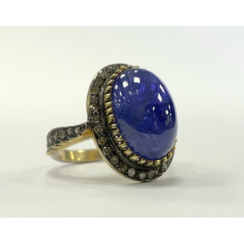 336 - A tanzanite and diamond cabochon ring, central tanzanite oval cabochon approx 7.20ct surrounded by o... 