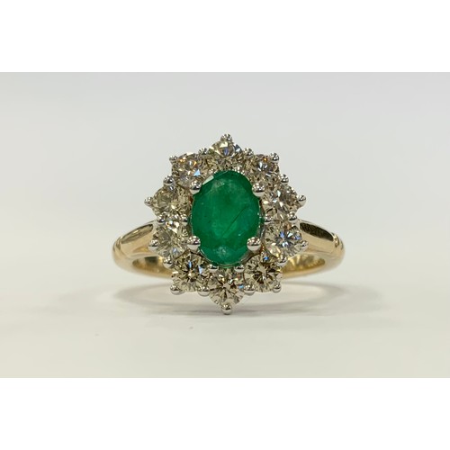 338 - An Emerald and diamond cluster ring, central oval mid green emerald approx 0.85ct, surrounded by a h... 