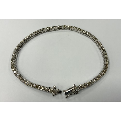 344 - A diamond tennis bracelet, set with sixty two round brilliant cut diamonds, total estimated diamond ... 