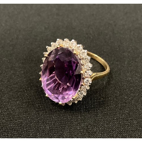 345 - A diamond and amethyst cluster ring, large oval mixed cut amethyst approx 10.00ct, surrounded by a h... 