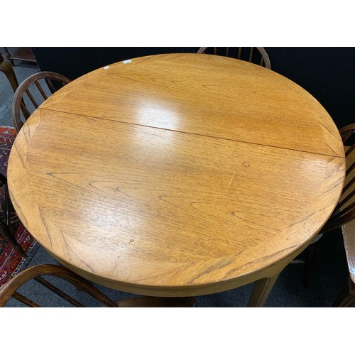 195 - A Nathan Furniture extending dining table, 75cm high x 122cm diameter;  with a set of four mid 20th ... 