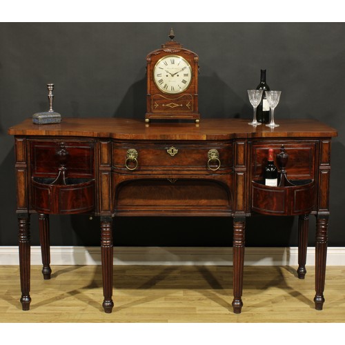 2521 - An unusual Regency mahogany sideboard or serving table, slightly oversailing top above a central fri... 
