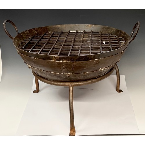 419 - A round cast iron fire pit, tripod support, the pit 61cm wide, 48.5cm high over handles