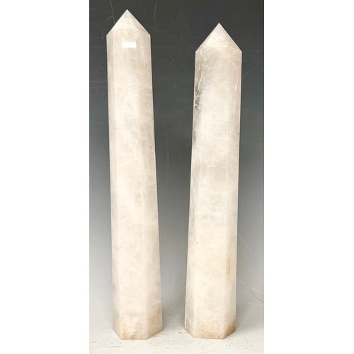 77 - A pair of Rock crystal white quartz obelisks of slightly tapering hexagonal form, 29.5cm high and 31... 