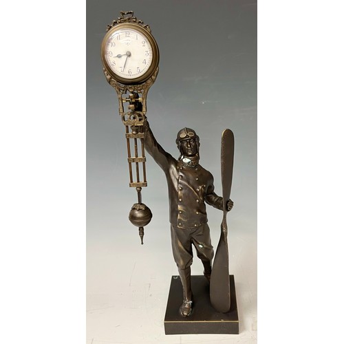 464 - A bronzed metal mystery clock modelled as an aviator, approx. 38.5cm high