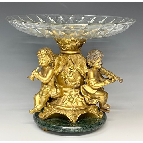 465 - A reproduction 19th century style table centre, the gilt metal support cast as a pair of cherub musi... 