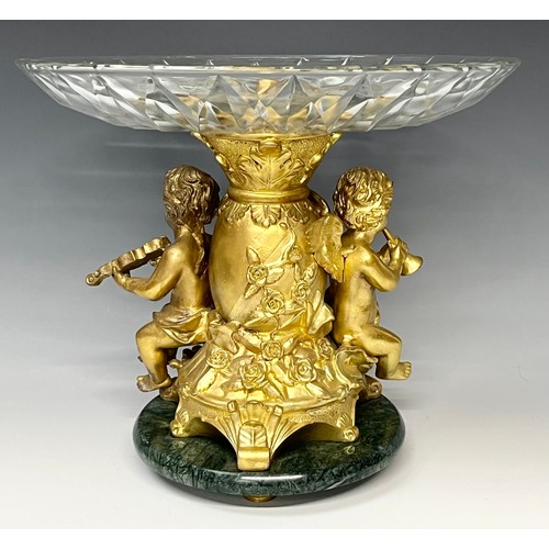 465 - A reproduction 19th century style table centre, the gilt metal support cast as a pair of cherub musi... 