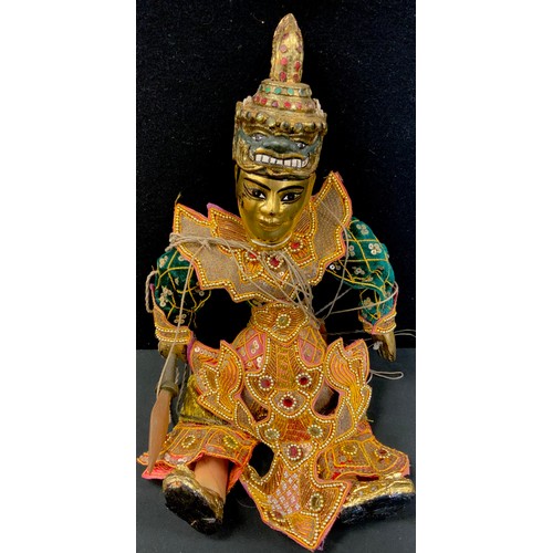 45 - A Burmese or Thai marionette puppet doll, as a warrior;  assorted wall masks,  pair of painted panel... 