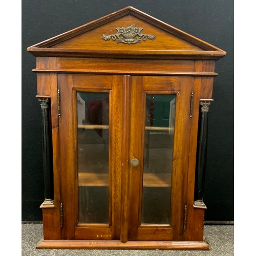 115 - A small mahogany wall hanging display/specimen cabinet, shaped pediment above two bevelled glass doo... 